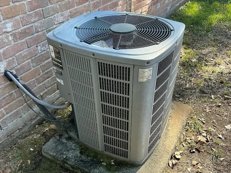 Residential AC condenser serviced by Prestige Air Service in Willis, TX